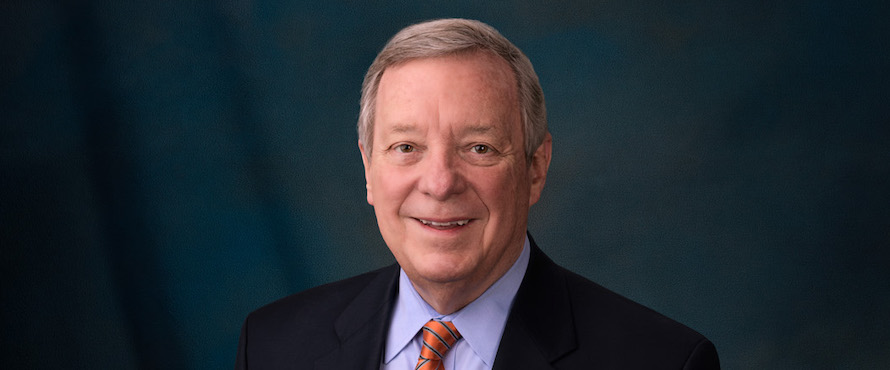 Photo of Sen. Richard J. Durbin in a dark suit, smiling. 