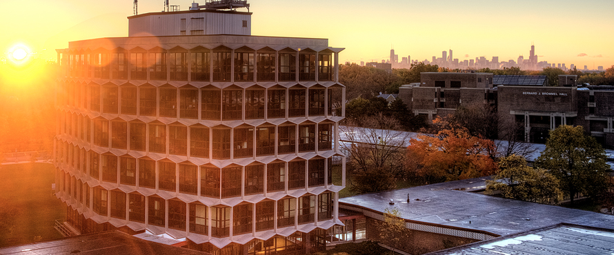 An aerial photo of the Sachs Administrative Building at sunrise with the Chicago skyline in the upper right corner background.
