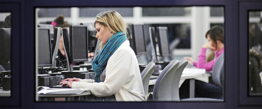 A photo of a person typing in a computer lab on Northeastern Illinois University's Main Campus.