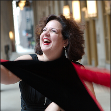 Photo of Rose Guccione smiling in a black and red dress