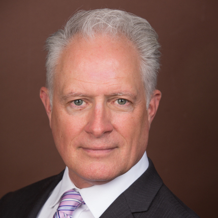 Photo of Gregory Franklin Rehner in a black suit jacket and striped tie