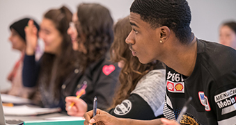 Medium shot of students participating in class.