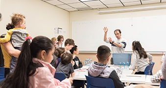 Teacher instructing young children