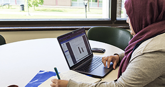 A student using a laptop.