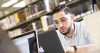 A student using a laptop.