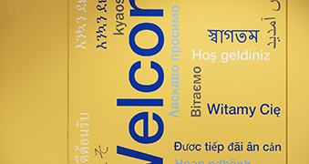 A poster with welcome written in different languages.