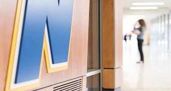 NEIU hallway with student in background