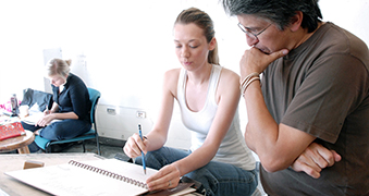 Man and woman interacting in art class.