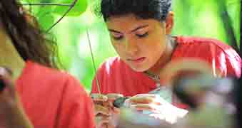 Female student examining an object