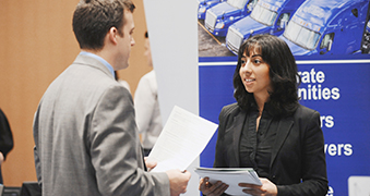 Man and woman conversing at an event.