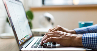 A student using a laptop.