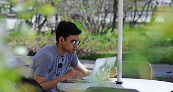 Northeastern student on a laptop.