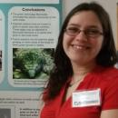 Photo of the Natural Science Technical Assistant Sara in front of a research poster.