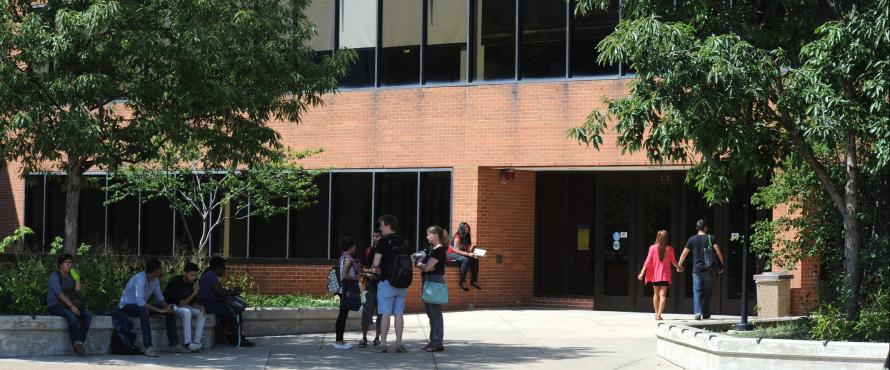 Students walking and hanging out in front of the Student Union.