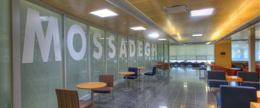 MOSSADEGH spelled out in large capital letters on the windows in Mossadegh Servant Leaders Hall in the College of Business and Management