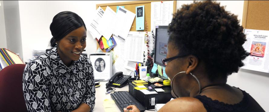 Advisor Amie Jatta (left) meets with a student in her office.