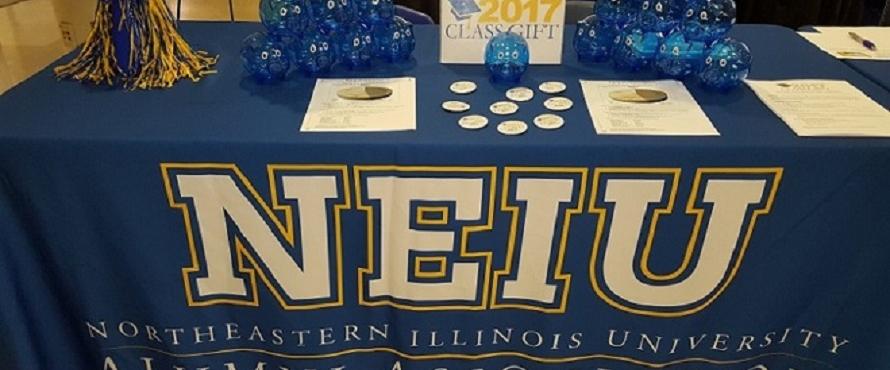 NEIU is shown on a blue tablecloth.