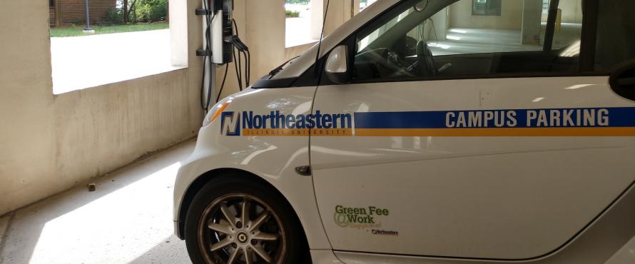 Photo of Northeastern's Campus Parking car at a car charging station 