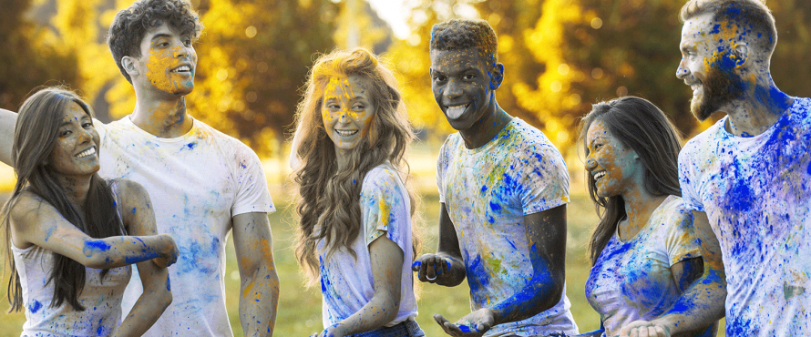 Group of students play with powder paint
