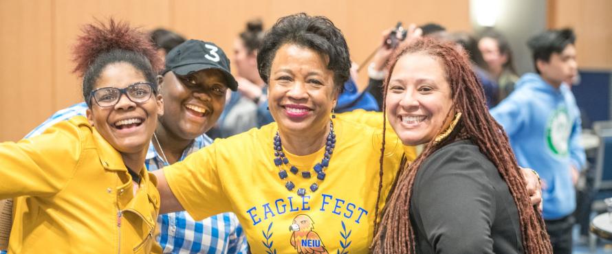 President Gloria Gibson poses with three other people at Eagle Fest