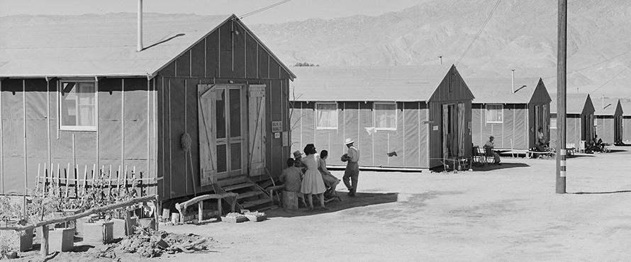 Manzanar Relocation Center, Manzanar, California. Barrack homes at this War Relocaton Authority center. The family in the foreground have commenced a flower garden to make their surroundings more home-like.