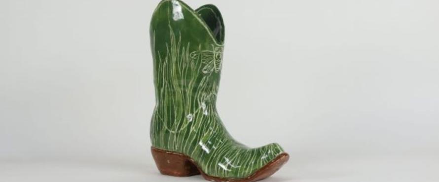 Green ceramic cowboy boot with grass and insect design
