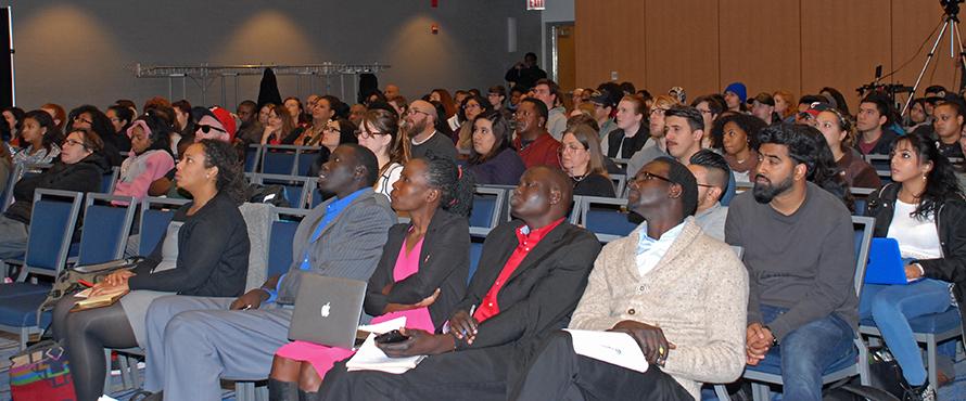 Audience members listening to a presentation.