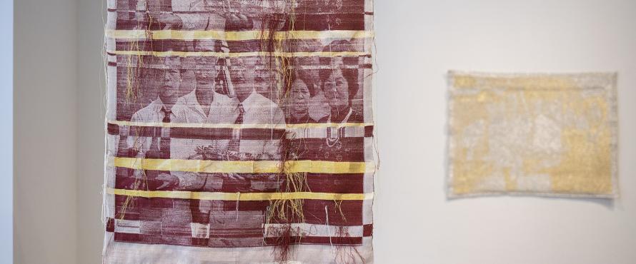 Woven images of asian people in burgundy and gold