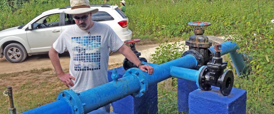 Earth Science Department Coordinator Ken Voglesonger examines one of the pumps that supply groundwater to the city.
