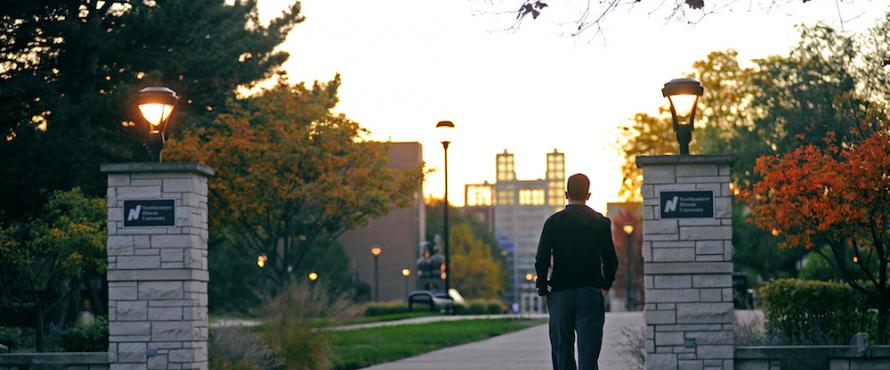 A student walks toward the Main Campus.
