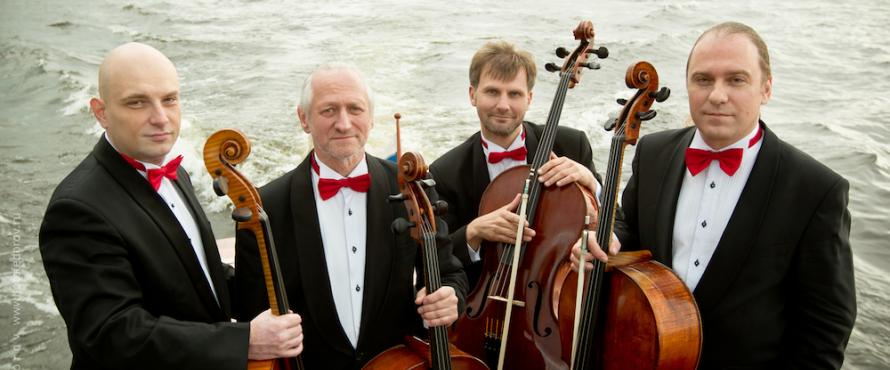 Rastrelli Cello Quartet wearing black tuxedos with red bow ties, each is holding a cello