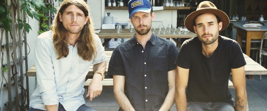 The three male members of the East Pointers sit next to each other in a row