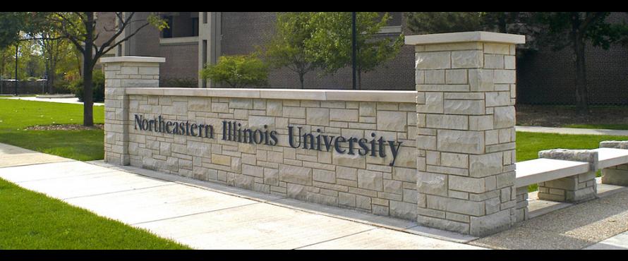 A low exterior, decorative wall bears the words Northeastern Illinois University