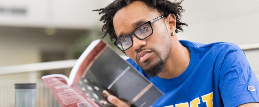 Graduate student Byron Terry reading a book
