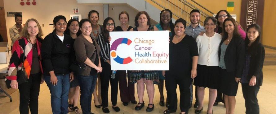 About 20 volunteers pose with a ChicagoCHEC sign.
