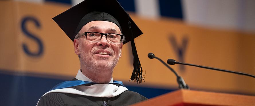 Billy Ocasio smiles while delivering his Commencement address.