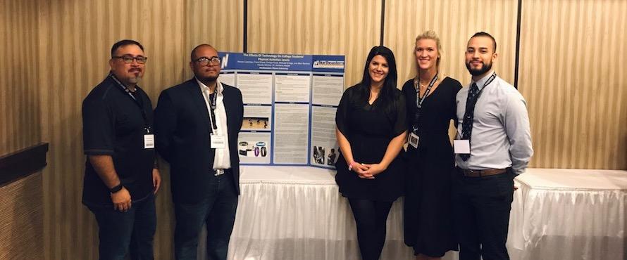Photo of Moises Clambas (left), Allen Ramirez, Carolyn Crost, Trace Chase and Michael Ortega pose with their student research presentation, “The Effects of Technology on College Students’ Physical Activity Levels” at IAHPERD.