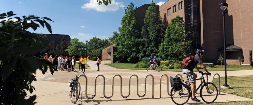 The University Commons with people walking and riding bicycles