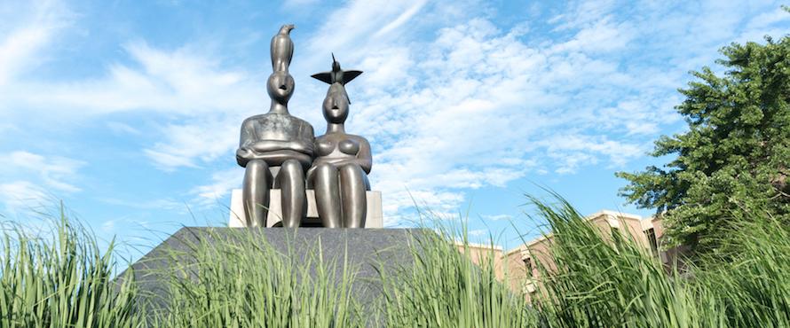 Ruth Duckworth's "Serenity" statue seen agains a blue sky and wispy white clouds