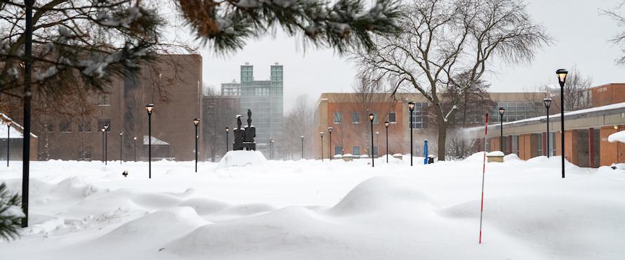 Snow blankets the University Commons as seen from the eastern entrance