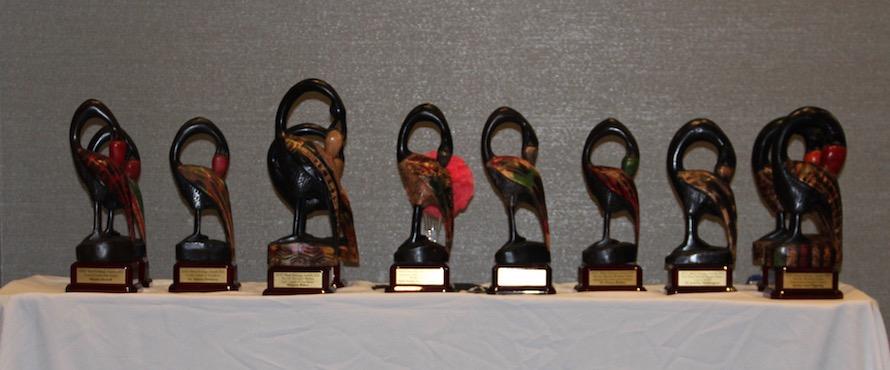Nine Sankofa statuettes stand in a row on a table