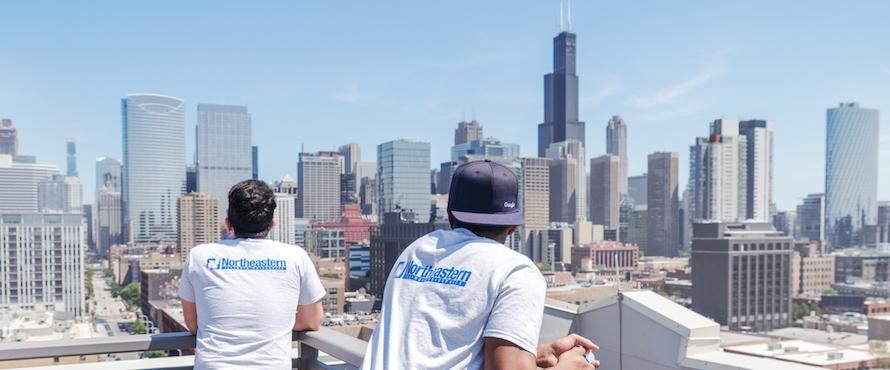 Two students look toward the Chicago skyline from El Centro's upstairs patio