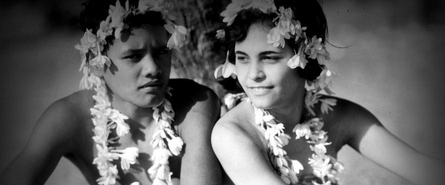  A black and white still image of two people wearing flower crowns and necklaces from the film “Tabu: A Story of the South Seas.” Courtesy of the Chicago Film Society.