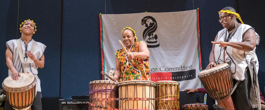 A photo of three drummers at a Harambee event organized by the Black Heritage Committee. 