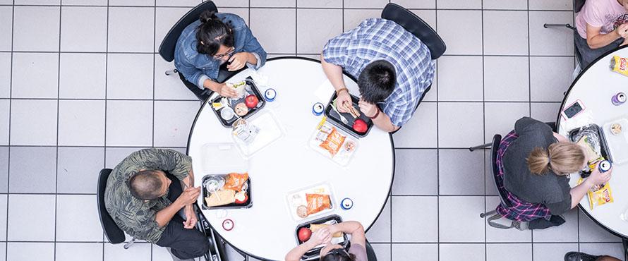 An overhead view of students sitting in the Cafeteria