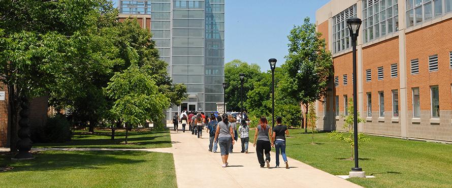 A group of people walking on campus.