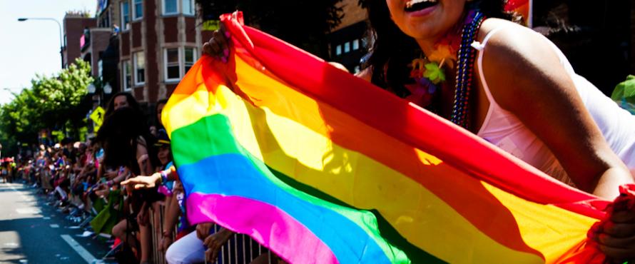 Woman holding a rainbow Pride flag