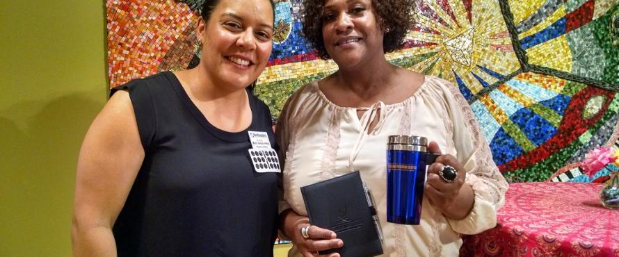 Scavenger hunt winner, student Cherry Blakely receiving her prizes from Maria Genao-Homs, Executive Director, Pedroso Center. 