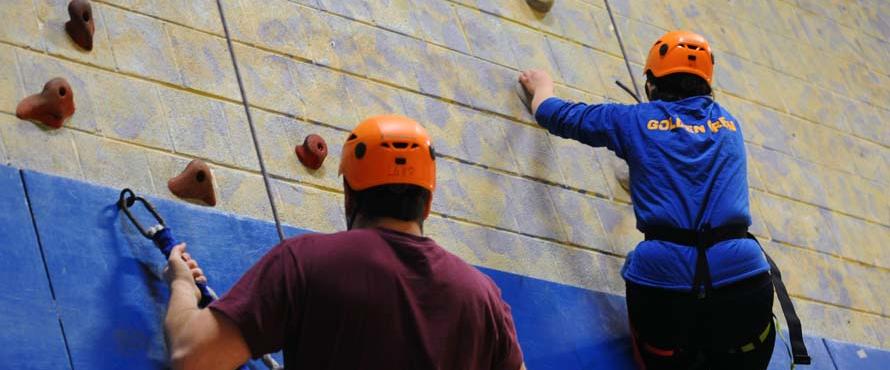 Climbers climbing wall