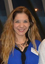 Denise E. Roman smiles at the camera.